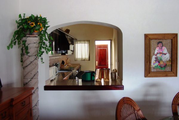 На этом фото в дизайне кухни используется два окна - раздаточное и межкомнатное