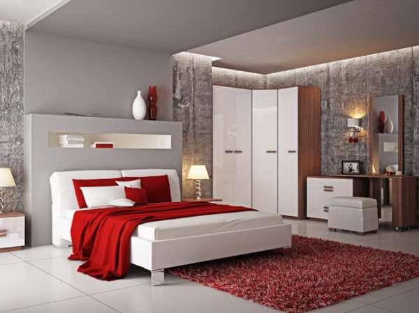 Спальня в стиле минимализма с красным акцентом. Белоснежные фасады мебели очень освежают серые стены комнаты.